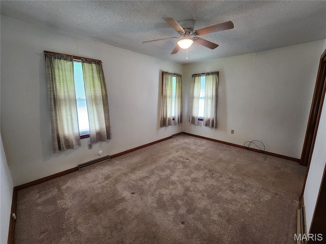 4028 Mcmasters Ave, Hannibal, MO 63401 - spare room with carpet, a textured ceiling, a ceiling fan, and baseboards