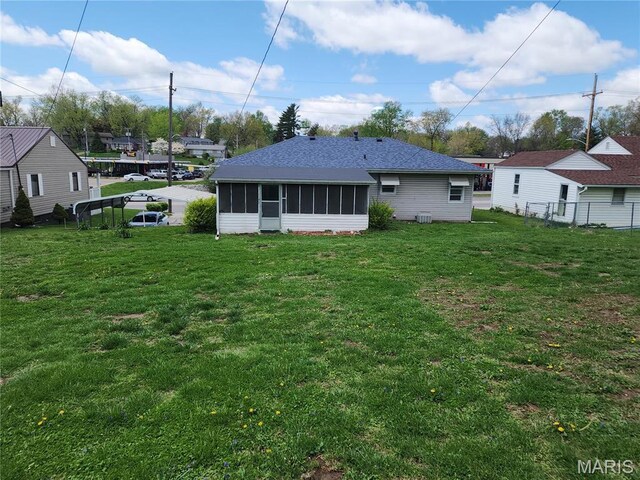 4028 Mcmasters Ave, Hannibal, MO 63401 - rear view of property with a sunroom and a shingled roof