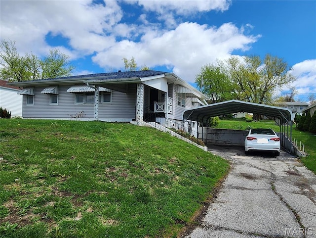 4028 Mcmasters Ave, Hannibal, MO 63401 - view of property exterior featuring a lawn, a carport, driveway, and covered porch