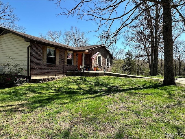 34 Kathryn Dr, St James, MO 65559 - rear view of property with brick siding and a lawn