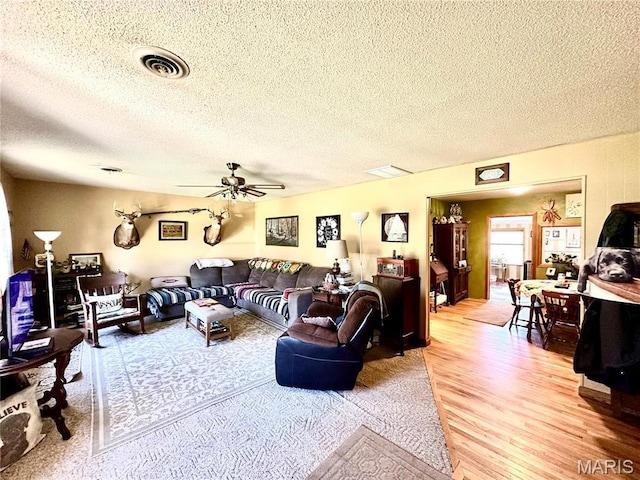 34 Kathryn Dr, St James, MO 65559 - living area with light wood finished floors, a textured ceiling, and ceiling fan