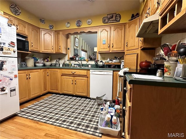 34 Kathryn Dr, St James, MO 65559 - kitchen with white appliances, extractor fan, light wood-type flooring, dark countertops, and a sink