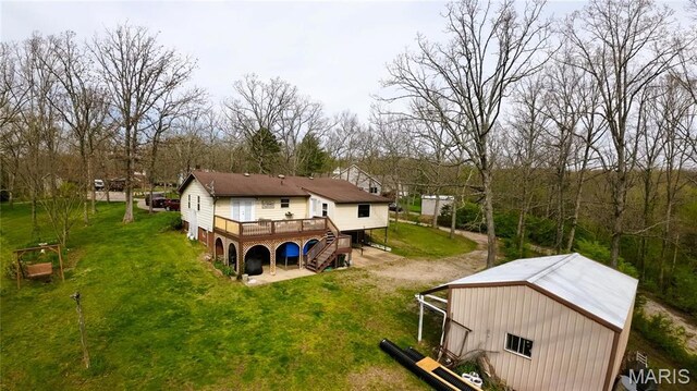 34 Kathryn Dr, St James, MO 65559 - rear view of house with a yard, a wooden deck, a pole building, and an outbuilding