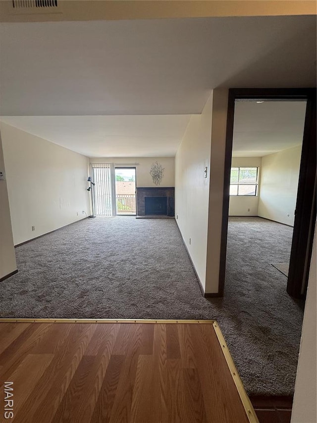 1530 Springlet Ct Unit 32, Florissant, MO 63033 - unfurnished living room featuring carpet floors and a fireplace