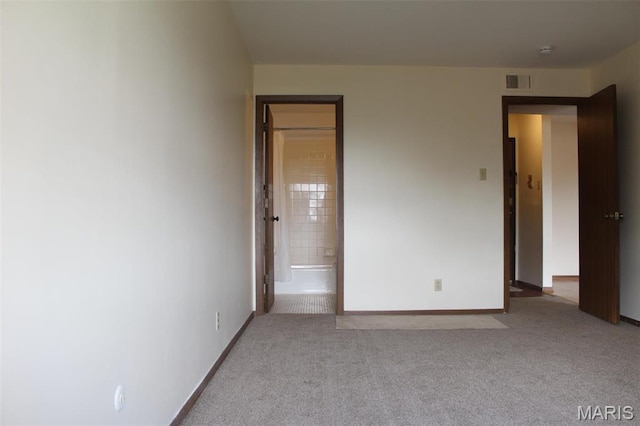 1530 Springlet Ct Unit 32, Florissant, MO 63033 - unfurnished bedroom featuring carpet floors, baseboards, and connected bathroom