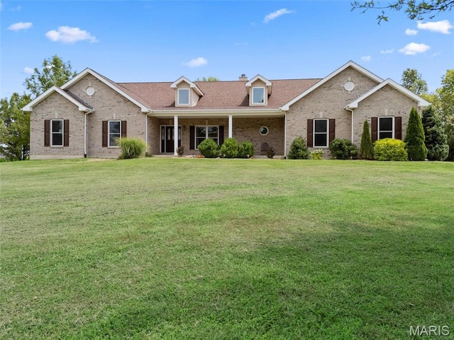 220 Cuivre Point Ln, Moscow Mills, MO 63362 - view of front of house featuring brick siding, a chimney, a front yard, and covered porch