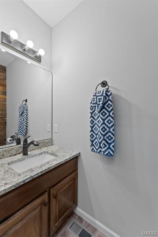 220 Cuivre Point Ln, Moscow Mills, MO 63362 - bathroom with vanity, baseboards, and wood finished floors