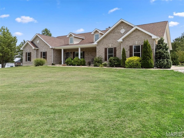 220 Cuivre Point Ln, Moscow Mills, MO 63362 - view of front of home featuring brick siding, a front yard, and a shingled roof