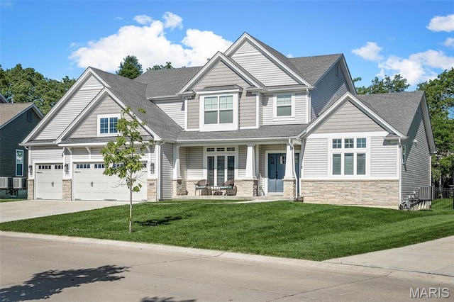207 Castle Stuart Ct, Dardenne Prairie, MO 63368 - craftsman-style home with stone siding, covered porch, driveway, a front lawn, and roof with shingles