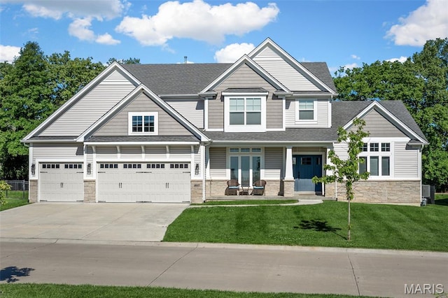 207 Castle Stuart Ct, Dardenne Prairie, MO 63368 - craftsman-style home featuring concrete driveway, stone siding, a front yard, roof with shingles, and covered porch
