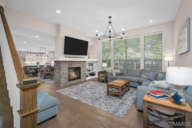 207 Castle Stuart Ct, Dardenne Prairie, MO 63368 - living area featuring stairway, wood finished floors, a chandelier, recessed lighting, and a stone fireplace