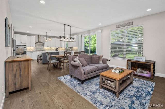 207 Castle Stuart Ct, Dardenne Prairie, MO 63368 - living area featuring wood finished floors, baseboards, and recessed lighting
