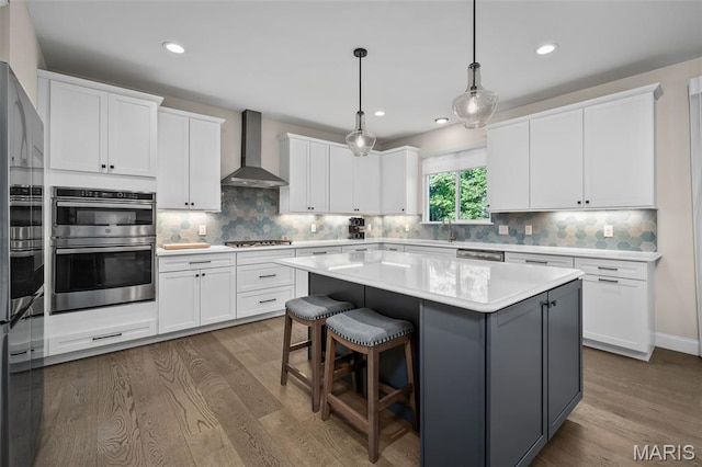 207 Castle Stuart Ct, Dardenne Prairie, MO 63368 - kitchen featuring wall chimney exhaust hood, dark wood finished floors, white cabinets, and recessed lighting