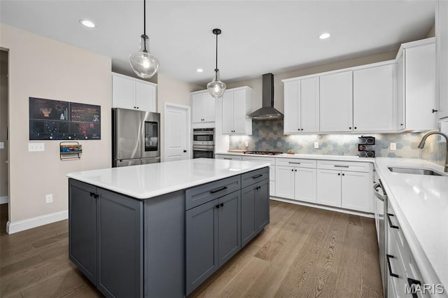 207 Castle Stuart Ct, Dardenne Prairie, MO 63368 - kitchen with appliances with stainless steel finishes, wall chimney range hood, a sink, gray cabinetry, and white cabinetry