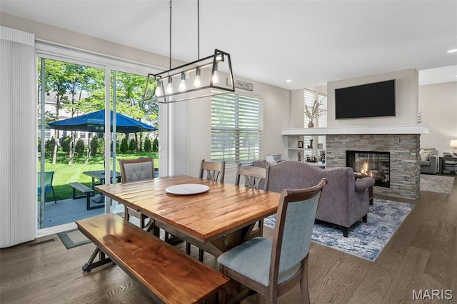 207 Castle Stuart Ct, Dardenne Prairie, MO 63368 - dining area with wood finished floors, a stone fireplace, and recessed lighting