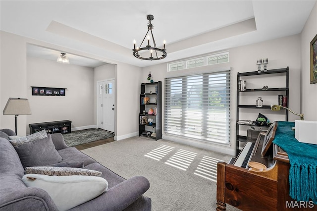 207 Castle Stuart Ct, Dardenne Prairie, MO 63368 - carpeted living area with a chandelier, a raised ceiling, and baseboards
