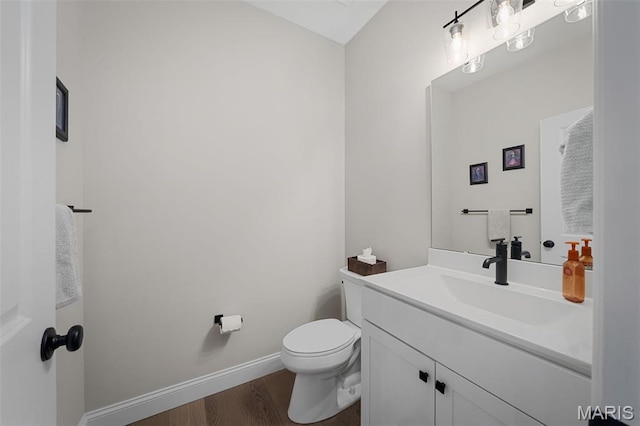 207 Castle Stuart Ct, Dardenne Prairie, MO 63368 - half bathroom featuring wood finished floors, toilet, vanity, and baseboards