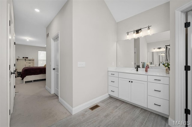 207 Castle Stuart Ct, Dardenne Prairie, MO 63368 - ensuite bathroom with baseboards, vanity, and vaulted ceiling