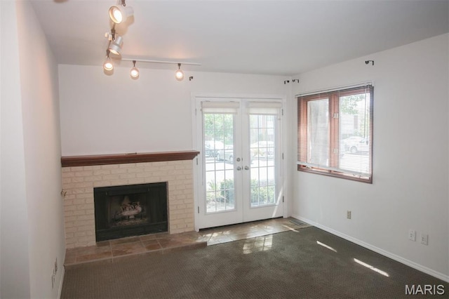 1340 Holgate Dr Unit F2, Ballwin, MO 63021 - unfurnished living room with carpet flooring, french doors, a fireplace, and rail lighting