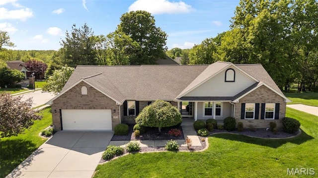view of front of home with driveway, an attached garage, brick siding, a front lawn, and a shingled roof