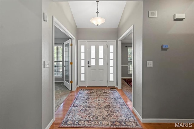 foyer entrance featuring light wood finished floors and baseboards