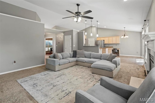 living area with light carpet, a ceiling fan, baseboards, a fireplace with flush hearth, and high vaulted ceiling