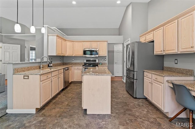 kitchen featuring appliances with stainless steel finishes, a sink, light brown cabinets, a kitchen island, and high vaulted ceiling