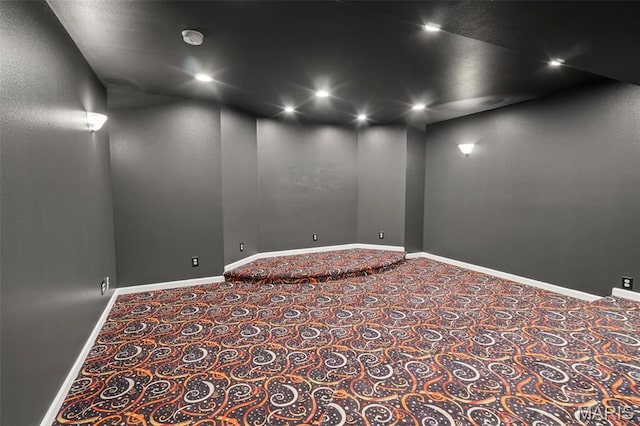 carpeted empty room featuring baseboards and recessed lighting