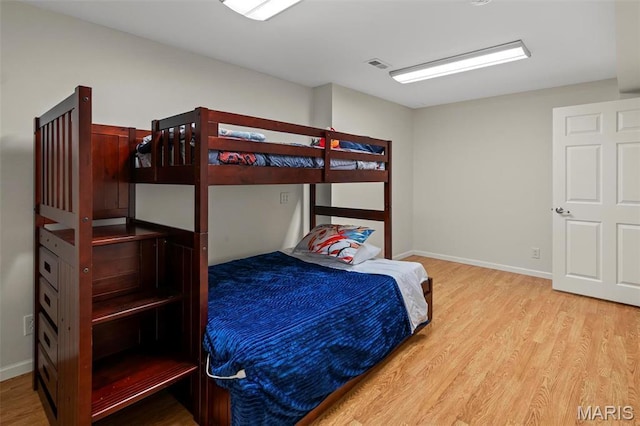 bedroom featuring wood finished floors and baseboards