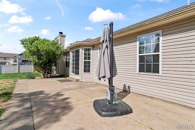 rear view of house with a patio and fence