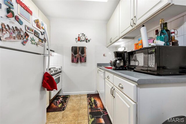 10457 Briarbend Dr Unit 8, Saint Louis, MO 63146 - kitchen featuring white appliances, tasteful backsplash, white cabinets, light countertops, and baseboards