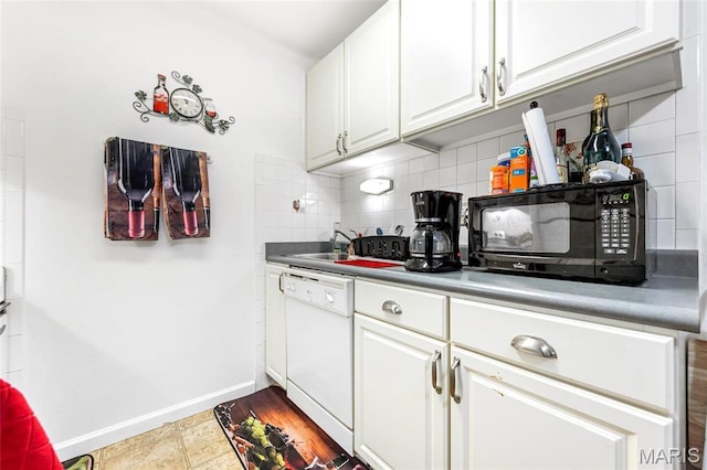 10457 Briarbend Dr Unit 8, Saint Louis, MO 63146 - kitchen with white dishwasher, black microwave, backsplash, baseboards, and white cabinetry