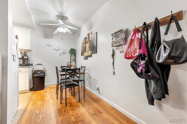 10457 Briarbend Dr Unit 8, Saint Louis, MO 63146 - dining space featuring a ceiling fan, light wood-style floors, and baseboards