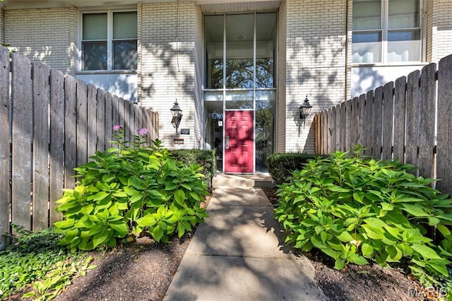 10457 Briarbend Dr Unit 8, Saint Louis, MO 63146 - doorway to property featuring brick siding and fence