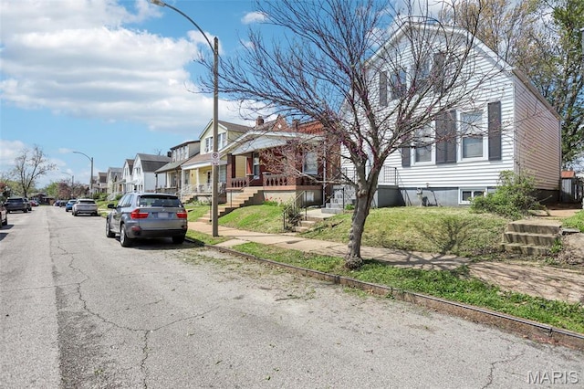 5327 W Ave, Saint Louis, MO 63116 - view of asphalt street featuring a residential view, street lighting, sidewalks, and curbs