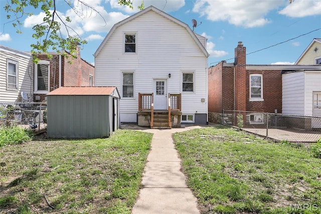 5327 W Ave, Saint Louis, MO 63116 - rear view of house with a storage unit, an outbuilding, and a gambrel roof