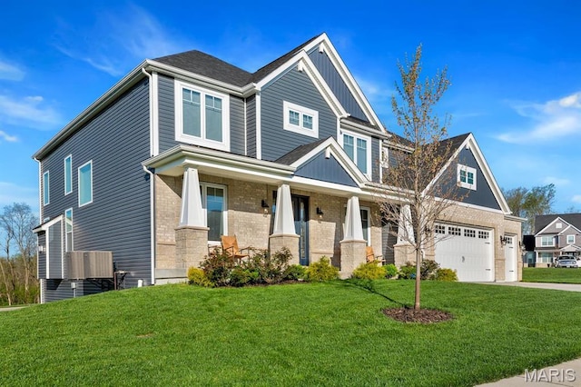 craftsman inspired home with a garage, concrete driveway, a porch, a front yard, and brick siding