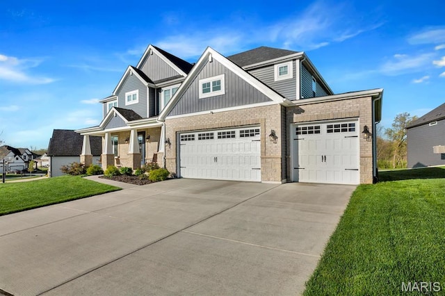 craftsman inspired home featuring driveway, an attached garage, a front lawn, and board and batten siding