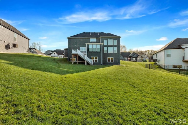 back of property with stairway, a residential view, and a deck