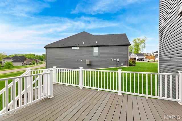 wooden terrace with a lawn and a residential view
