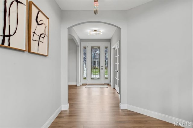 215 Everett Creek Ct, Lake St Louis, MO 63367 - entrance foyer featuring arched walkways, wood finished floors, and baseboards