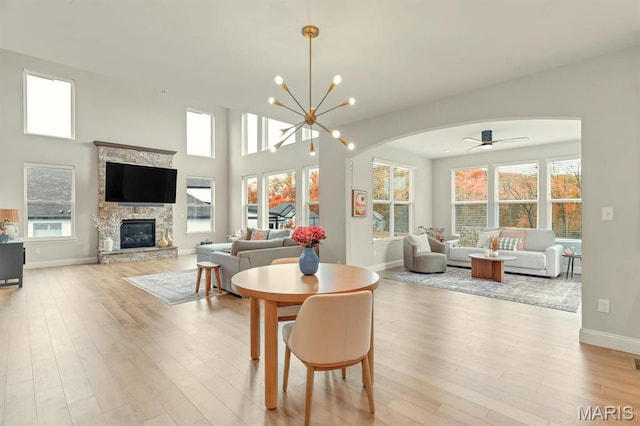 215 Everett Creek Ct, Lake St Louis, MO 63367 - dining space with arched walkways, wood finished floors, and plenty of natural light
