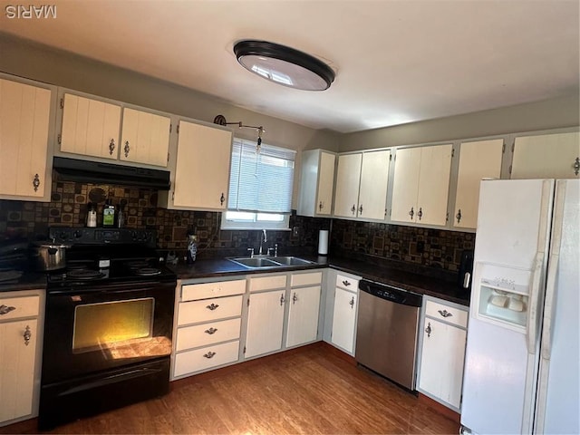 kitchen with white fridge with ice dispenser, stainless steel dishwasher, black electric range, under cabinet range hood, and a sink