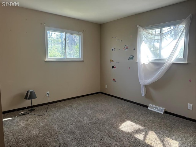empty room with carpet flooring and baseboards