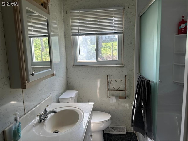 full bathroom featuring toilet, vanity, a shower, and a tub