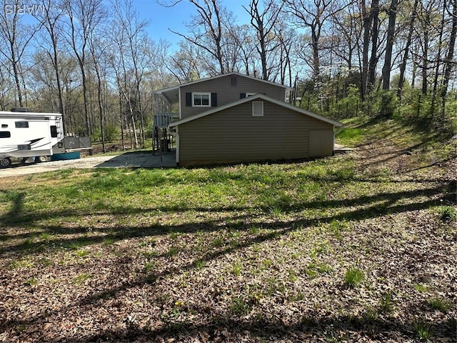 view of side of home with a lawn