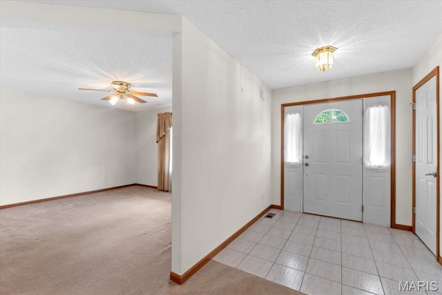 2305 Loretta Ln, Collinsville, IL 62234 - entryway with baseboards, a textured ceiling, ceiling fan, and light carpet