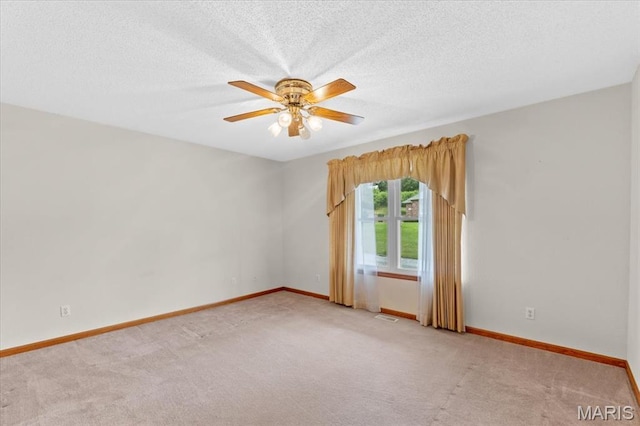 2305 Loretta Ln, Collinsville, IL 62234 - unfurnished room featuring light colored carpet, baseboards, ceiling fan, and a textured ceiling