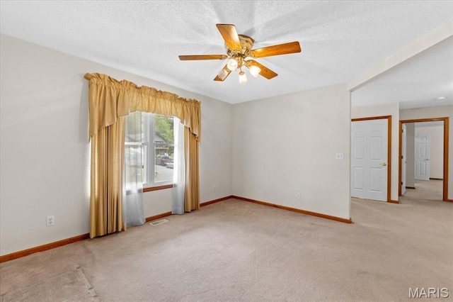 2305 Loretta Ln, Collinsville, IL 62234 - unfurnished room featuring light colored carpet, ceiling fan, baseboards, and a textured ceiling