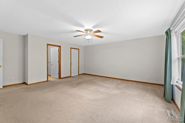 2305 Loretta Ln, Collinsville, IL 62234 - empty room with light carpet, a ceiling fan, baseboards, and a textured ceiling